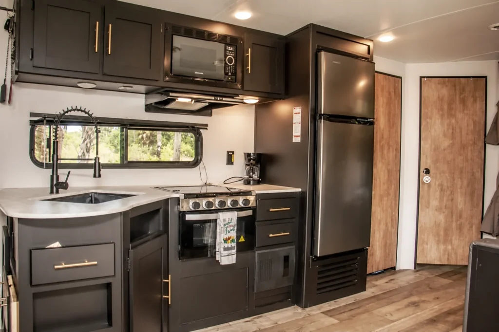 CPL 23 RV rental kitchen with stove sink refrigerator and microwave