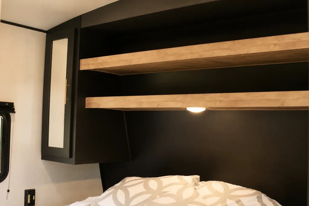 CPL 23 RV rental sleeping area with bunk bed and overhead storage
