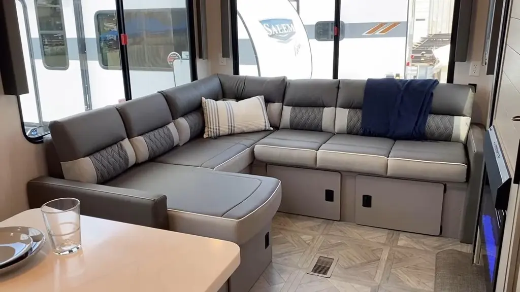 Spacious RV living area with a large sectional sofa and panoramic windows—RV rentals in Orlando